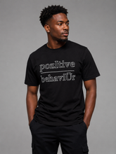 Load image into Gallery viewer, Man wearing a black t-shirt with 'pozltive behaviUr' text on a gray background